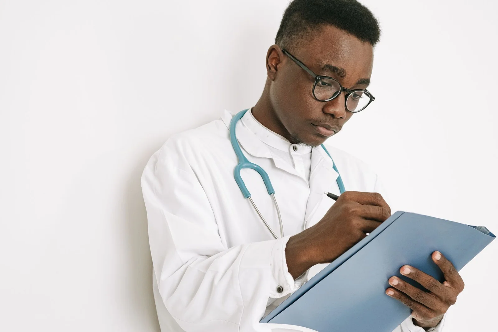 Doctor making notes on a clipboard